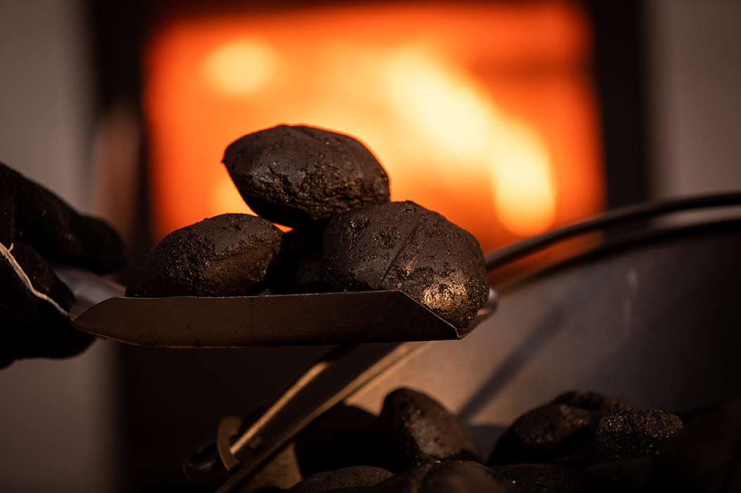 Homefire smokeless Ecoal briquettes beside a lit fire