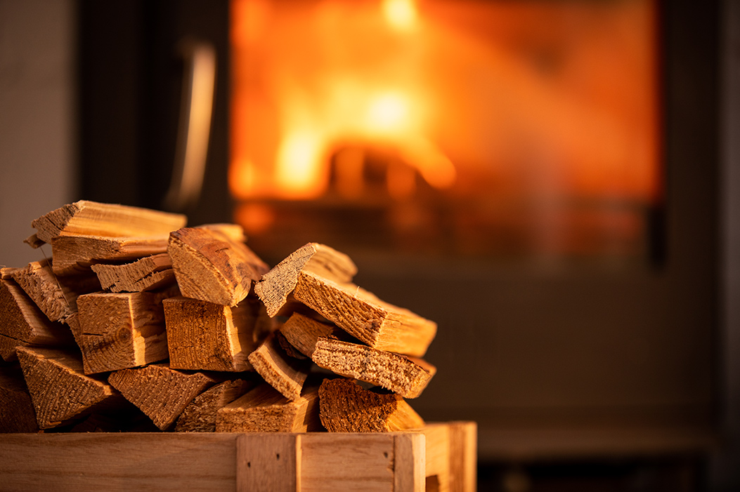 Homefire kiln-dried kindling beside a glowing wood burner